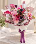 Bouquet of deep burgundy and pink calla lilies from FlowerPlus花加, showcasing elegant exotic floral arrangement.
