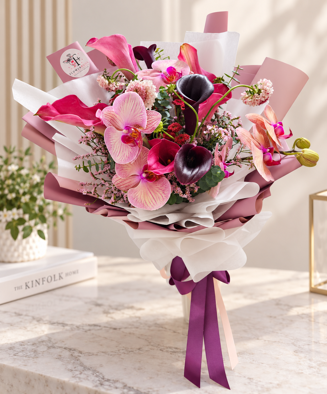 Bouquet of deep burgundy and pink calla lilies from FlowerPlus花加, showcasing elegant exotic floral arrangement.