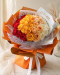 Bouquet of 99 mixed color roses from FlowerPlus花加, vibrant and fresh flower arrangement with lush green leaves.