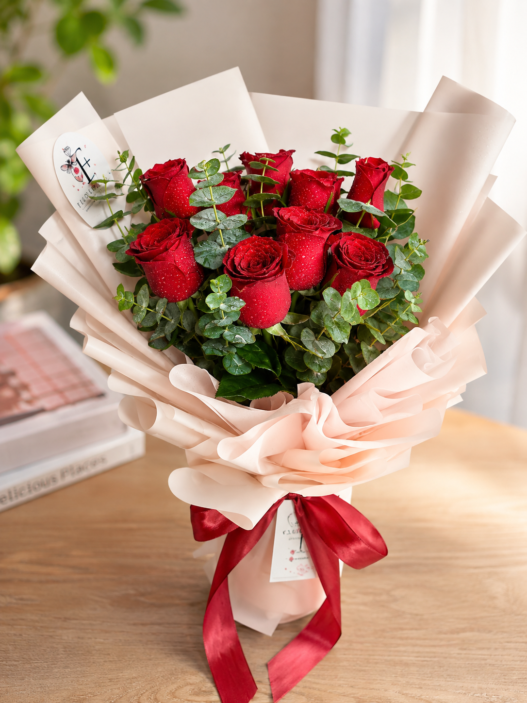 Red roses and eucalyptus in a romantic FlowerPlus花加 bouquet, lush and vibrant with fresh greenery.